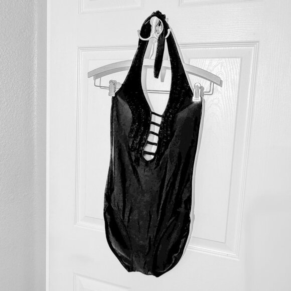 2.	One piece swimsuit, black, plunging V-neckline, body decorated with ruching. - Picture 1 of 4